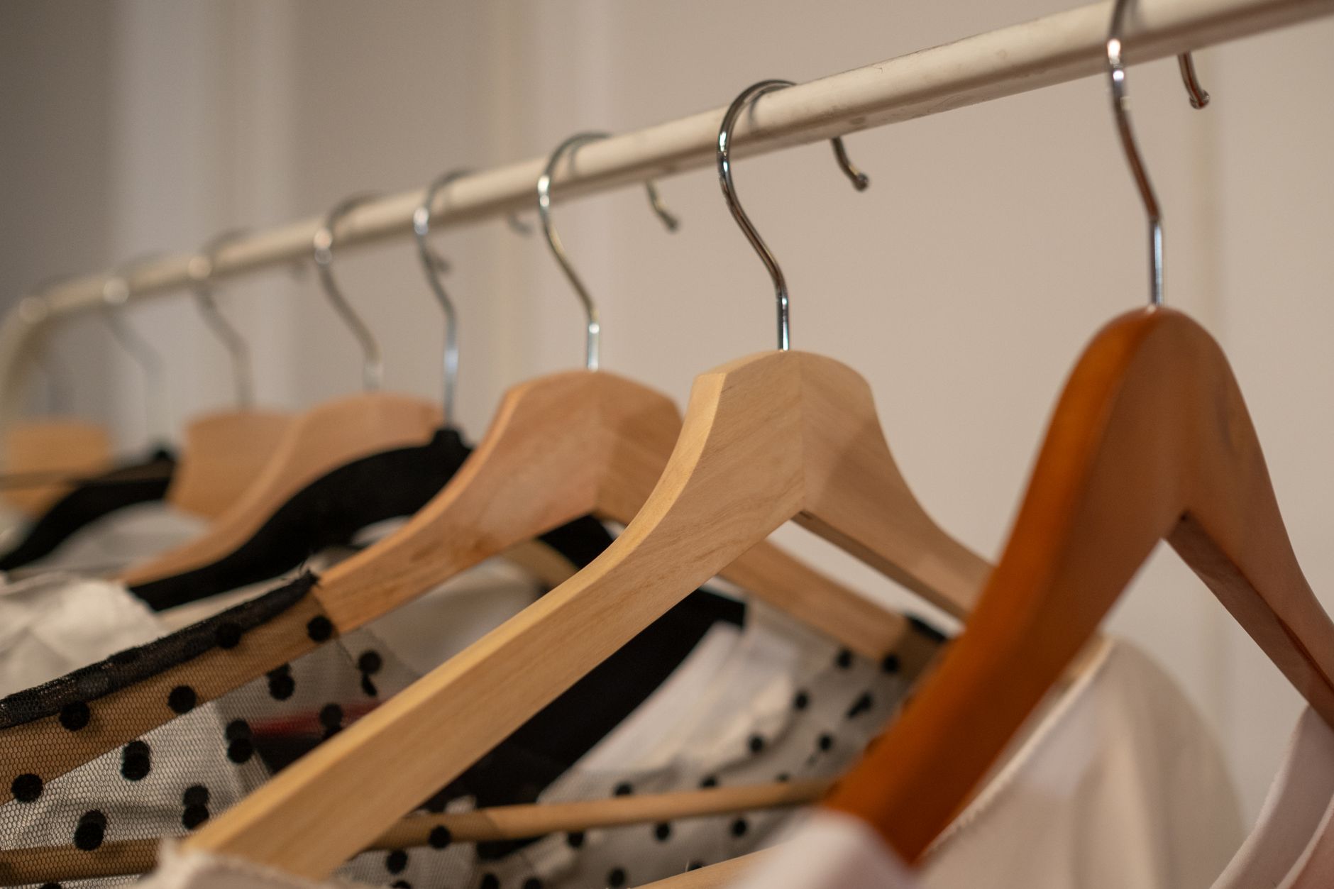 Curated clothing rail showing cost per wear wardrobe essentials