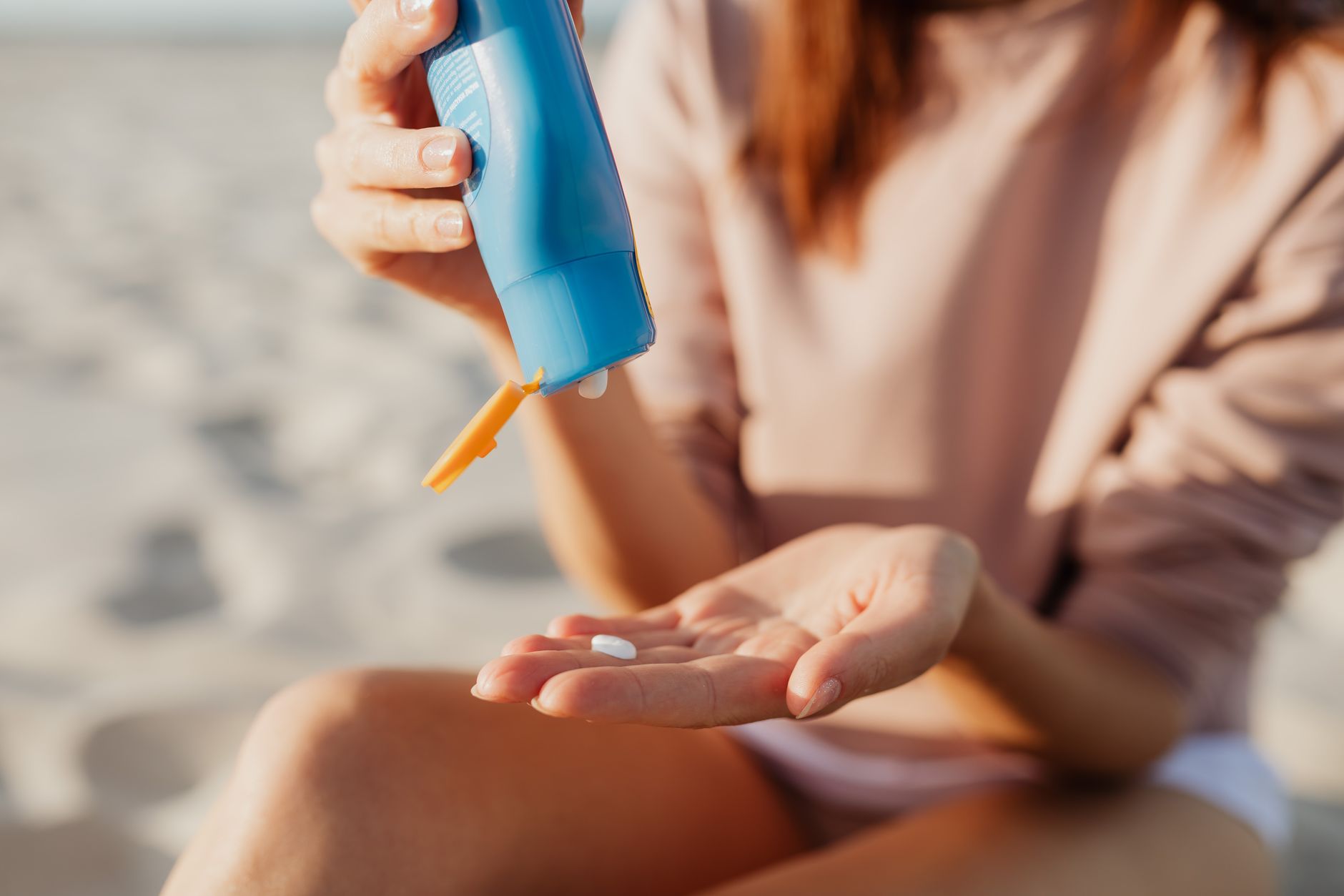 Woman applying SPF moisturiser to her face as part of a UK daily skincare routine