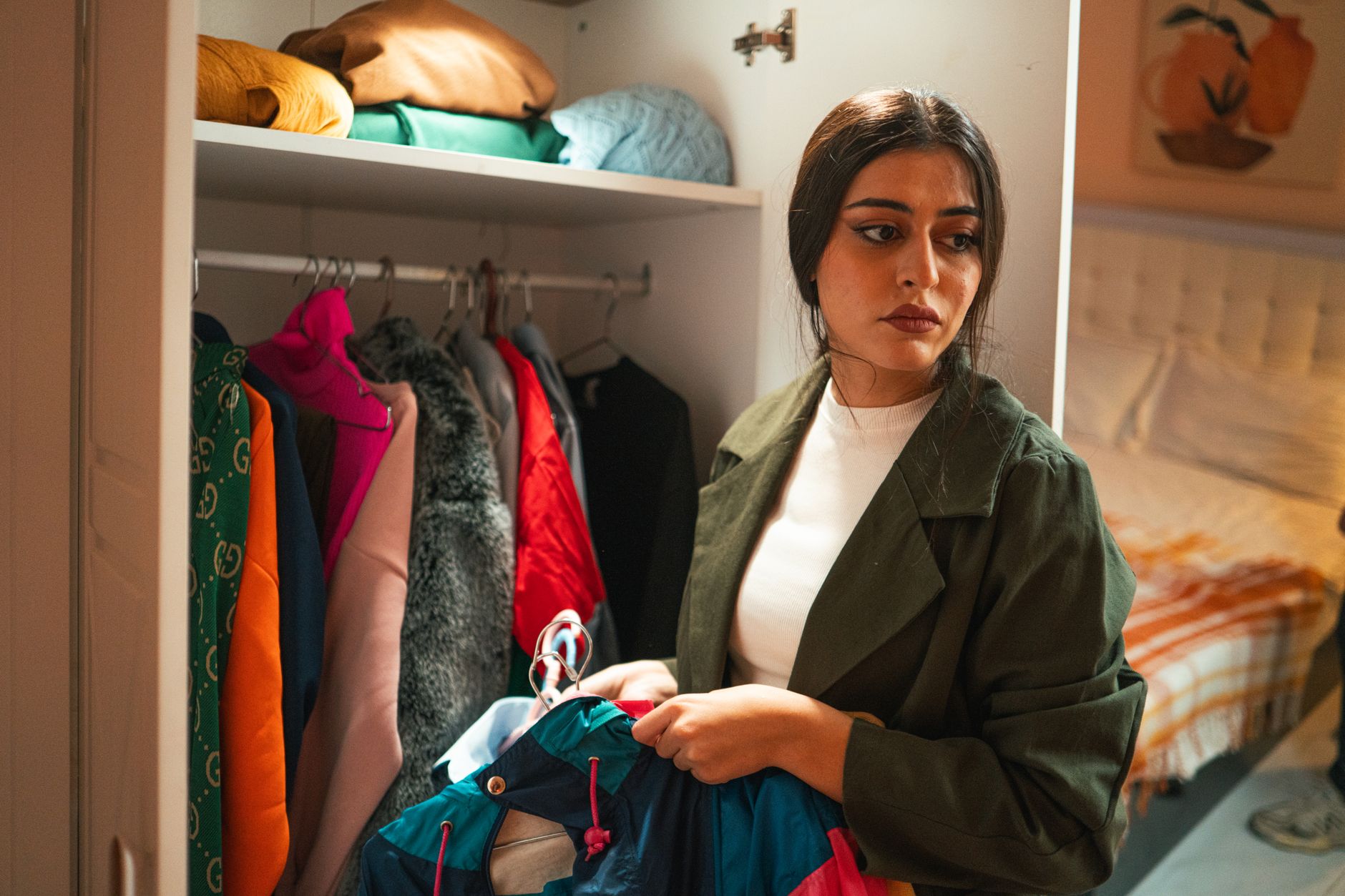 Woman reviewing wardrobe items to calculate cost per wear