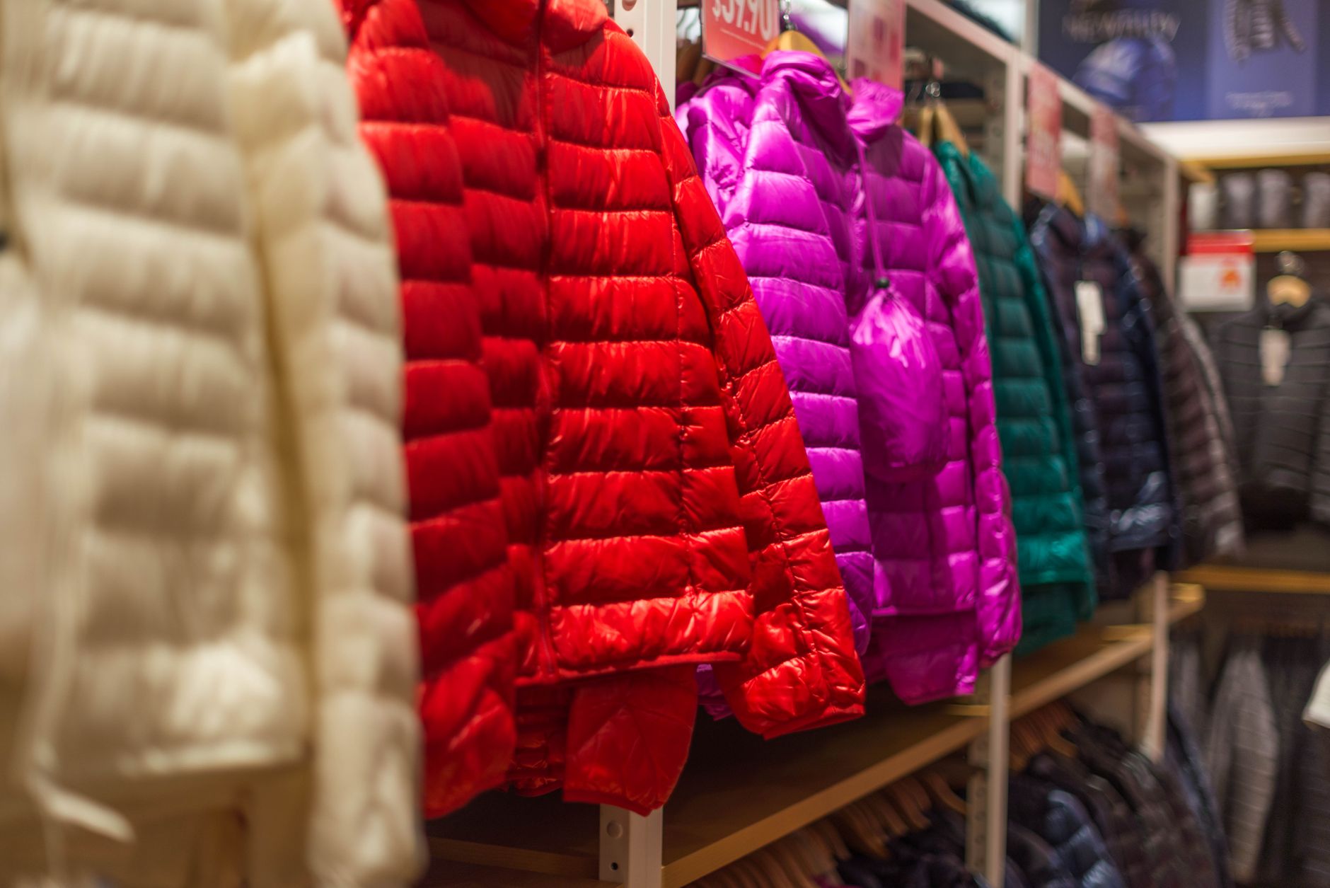 Close-up of clothes sorted by colour during a wardrobe audit process
