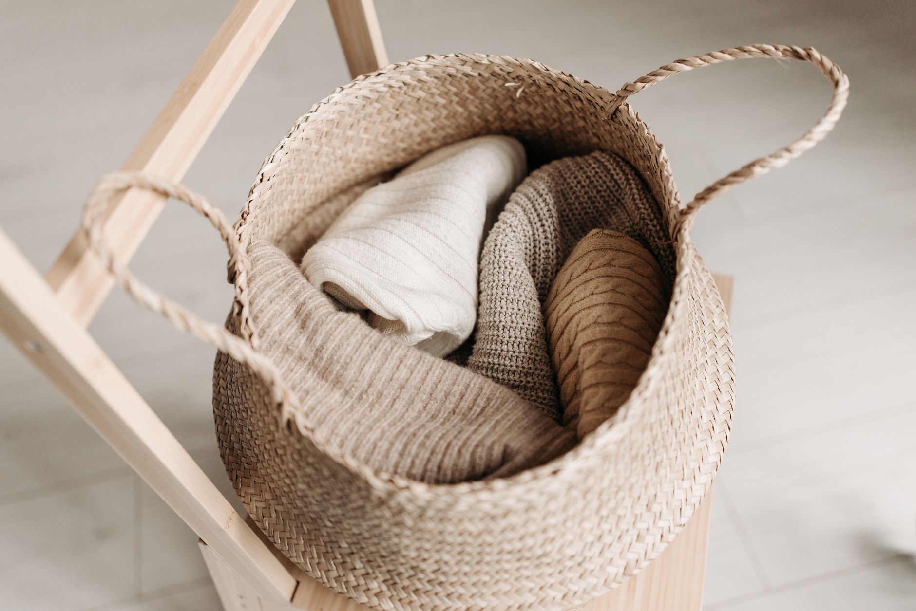Folded cashmere knitwear in neutral tones representing British quiet luxury investment dressing