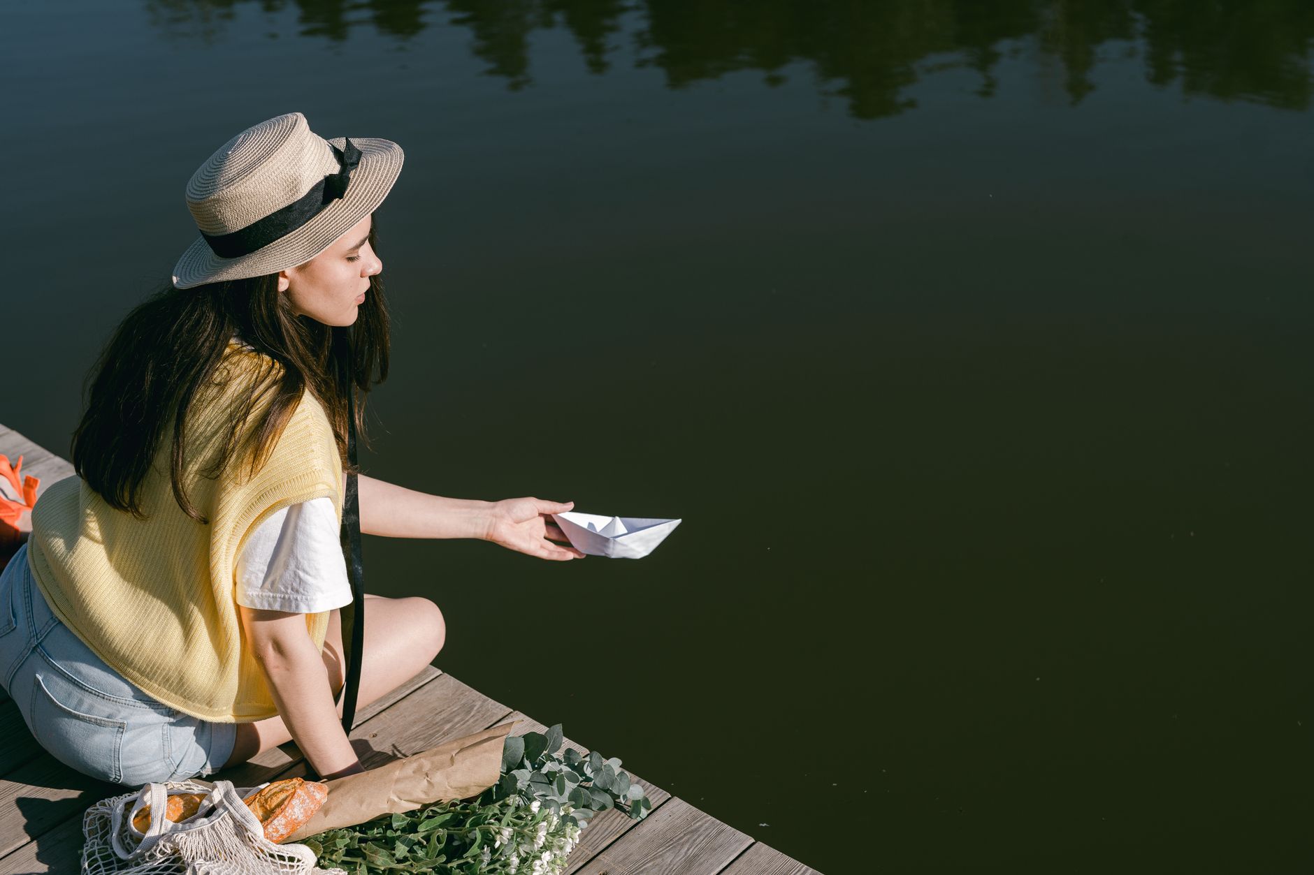 Stylish woman on narrowboat demonstrating a canal boat capsule wardrobe on an English waterway